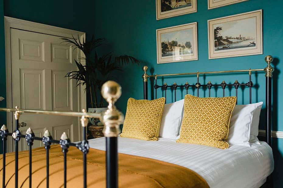 geometric yellow velvet scatter cushions on bed