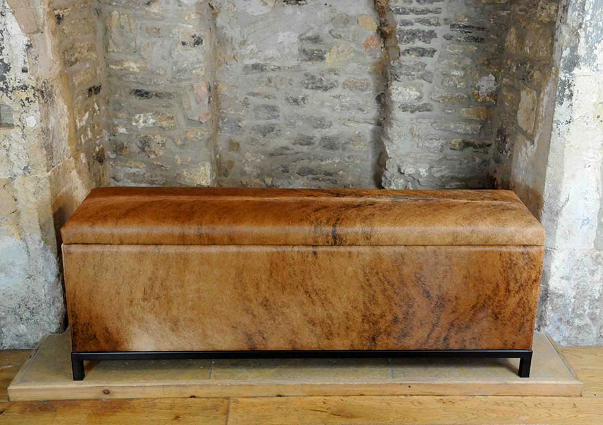 ottoman upholstered in cowhide