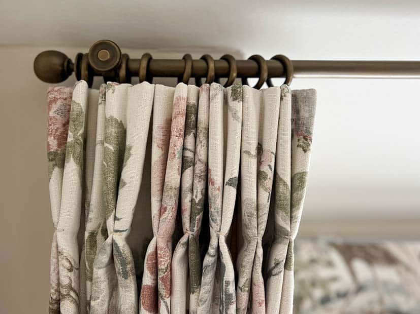 detail of wooden curtain pole with brass look finish